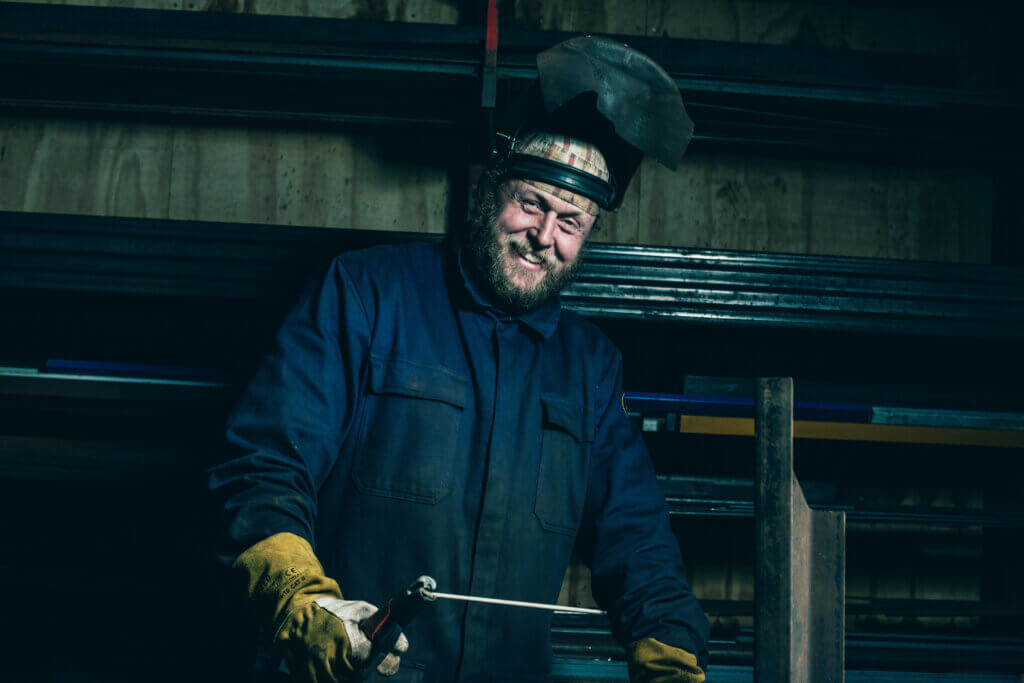Smiling welder in his workplace